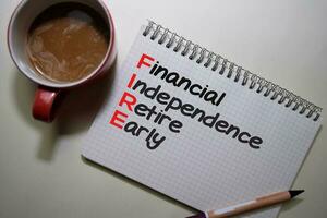 Financial Indipendence Retire Early write on a book isolated on Office Desk. photo