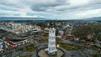 Aerial view of Jam Gadang, a historical and most famous landmark in BukitTinggi City, an icon of the city and the most visited tourist destination by tourists. Bukittinggi, Indonesia, January 25, 2023 photo