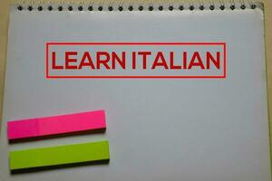 Learn Italian write on a book isolated on Office Desk photo