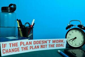 If the Plan doesn't work, Change the plan Not the goal Planning on Background of Working Table with Office Supplies. Business Concept Planning on Blue Background photo