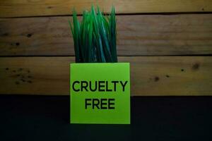 Cruelty Free write on a sticky note isolated on wooden background. photo