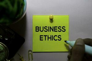 Business Ethics text on sticky notes isolated on office desk photo