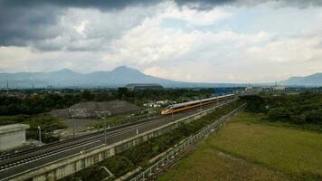 Aerial view of the High speed orange train on the railway station. High Speed Train Jakarta-Bandung. Bandung, Indonesia, November 22, 2022 photo