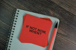 If Not Now, When write on sticky notes isolated on Wooden Table. photo