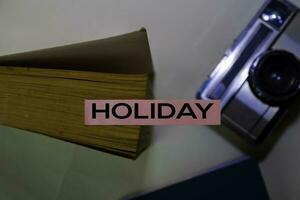 Holiday text on sticky notes isolated on desk background photo