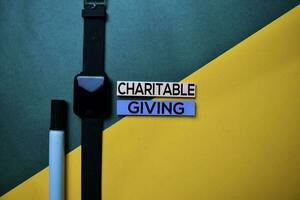 Charitable Giving text on top view color table background. photo