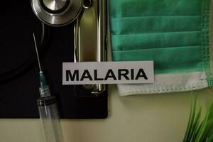 Malaria with inspiration and healthcare medical concept on desk background photo