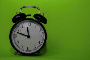 Close up Alarm Clock isolated on green background photo