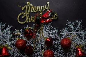 merry christmas text and Decorative Christmas isolated on black background photo