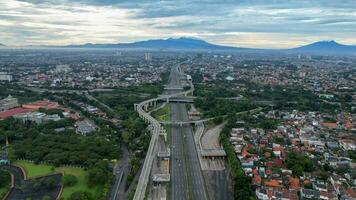 Aerial view of quiet traffic on Taman Mini street with mountain view during weekend in Jakarta city. Jakarta, Indonesia, March 8, 2022 photo