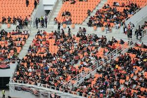 Crowds on Group of fans on the stadium Jakarta International Stadium. Jakarta, Indonesia, August 1, 2022 photo