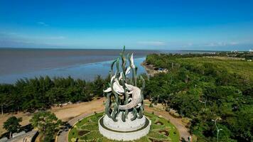 Aerial view of the A giant shark and crocodile statue as a symbol of the city of Surabaya. A landmark or monument as an icon of Surabaya city. East Java, Indonesia, August 28, 2022 photo