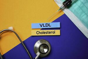 VLDL Cholesterol text on Sticky Notes. Top view isolated on color background. Healthcare Medical concept photo