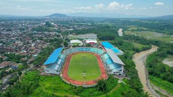 Aerial top down view of the Beautiful scenery of Moch. Soebroto Stadium. with Magelang cityscape background. Magelang, Indonesia, December 6, 2021 photo