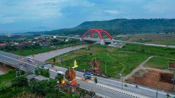 Aerial view of the Kalikuto Bridge, an Iconic Red Bridge at Trans Java Toll Road, Batang when sunrise. Central Java, Indonesia, December 6, 2021 photo