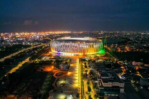 Aerial view of the Beautiful scenery of Jakarta International Stadium. with Jakarta cityscape background. Jakarta, Indonesia, March 8, 2022 photo