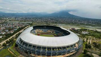 Aerial view of the Beautiful scenery Gelora Bandung Lautan Api  Football or Soccer Stadium in the Morning with Blue Sky. Bandung, Indonesia, November 22, 2022 photo