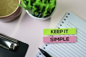 Keep it Simple text on sticky notes with office desk concept photo