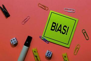 Bias write on sticky notes isolated on Pink background. photo