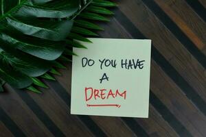 Do You Have A Dream write on sticky notes isolated on Wooden Table. photo