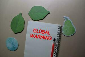 Global Warming write on a book isolated on Office Desk photo