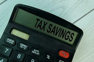 Tax Savings write on the calculator on Wooden Table. photo