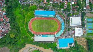 Aerial top down view of the Beautiful scenery of Moch. Soebroto Stadium. with Magelang cityscape background. Magelang, Indonesia, December 6, 2021 photo