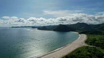 Aerial view of Selong Belanak, Tropical island with sandy beach and turquoise ocean with waves. Lombok. Indonesia, Mach 22, 2022 photo