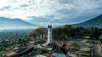 Aerial view of Jam Gadang, a historical and most famous landmark in BukitTinggi City, an icon of the city and the most visited tourist destination by tourists. Bukittinggi, Indonesia, January 25, 2023 photo