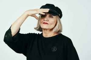 elderly woman in fashionable clothes black hat studio posing photo