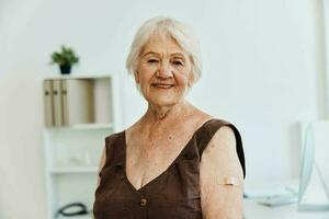 elderly woman with a plaster on her arm vaccine passport immunity protection photo