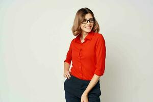 pretty business woman in red shirt work office light background photo