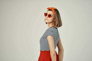 emotional woman wearing sunglasses in striped t-shirt posing fashion photo