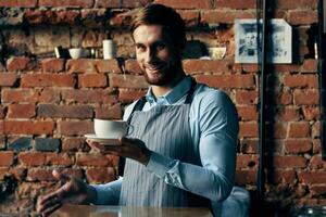 male waiter wearing apron coffee cup service lifestyle photo