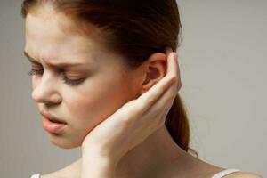 woman poor hearing disorders in white t-shirts isolated background photo