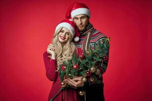 a man and a woman are standing next to the new year tree decoration holiday photo