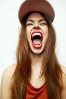 Emotional woman in a cap Wide open mouth closed eyes charm model photo