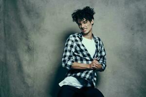 cute guy curly hair plaid shirt fashion emotions studio photo