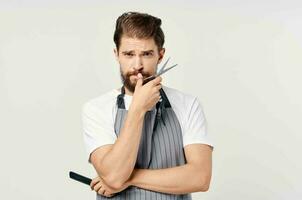 man in apron hairdresser comb scissors professional photo