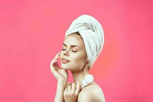 woman with bare shoulders and cosmetology clean skin relaxation pink background photo