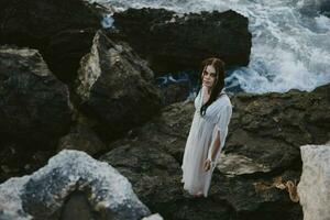 woman traveler walks volcanic rock formations on the island Lifestyle photo