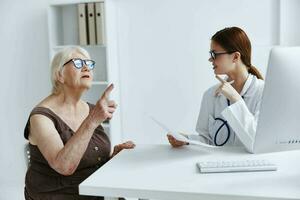 elderly woman with glasses examination by a doctor health complaint photo