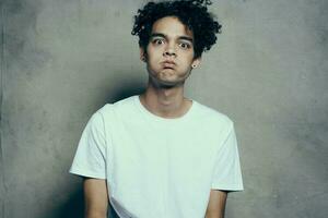 emotional man curly hair white t-shirt close up photo