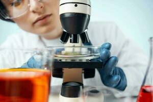 woman laboratory assistant microscope diagnostics research microbiology photo