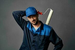 a man in a working uniform a painter renovation of an apartment decoration work photo