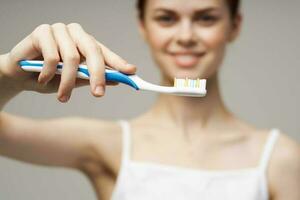 woman with a toothbrush in hand morning hygiene studio lifestyle photo