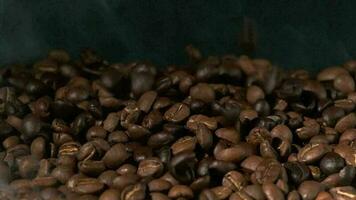 Slow motion of roasted coffee beans falling. video