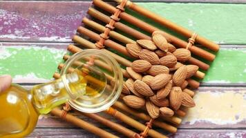 almond nut and oil pouring in a container on table video