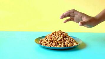 man hand taking nut from a plate video