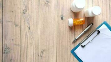 close up of pill container, paper and pen on clinic desk video